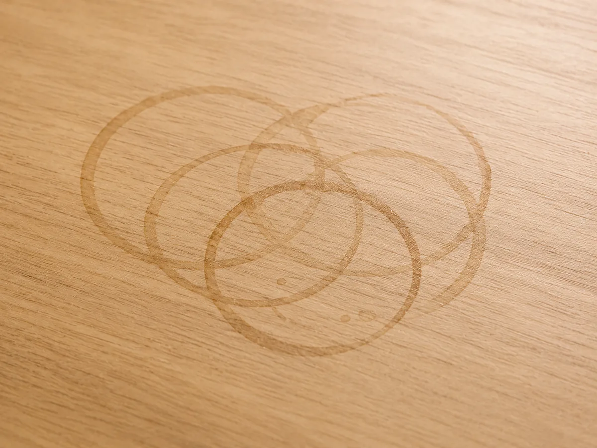 Overlapping ring marks left on a bare wooden table