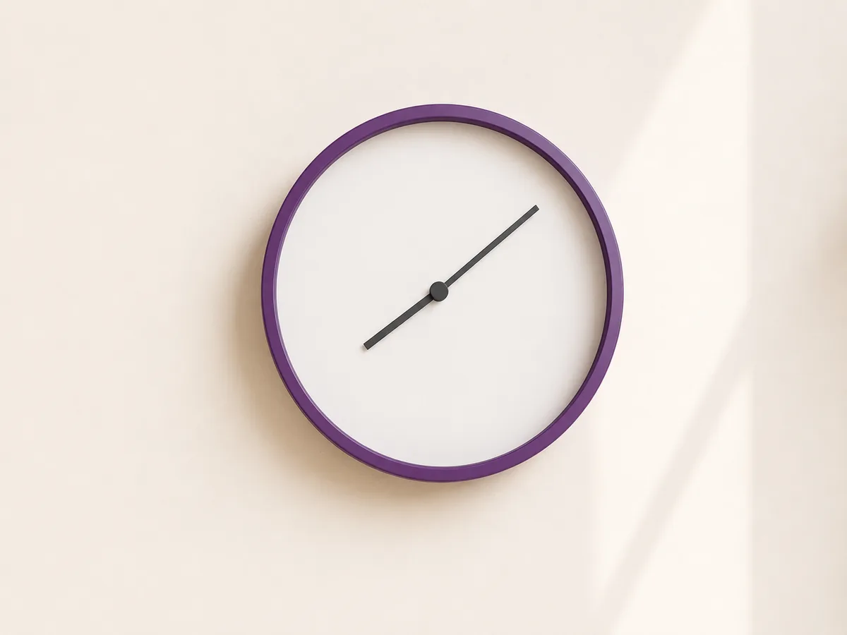 A clock on a pale wall showing hours passing